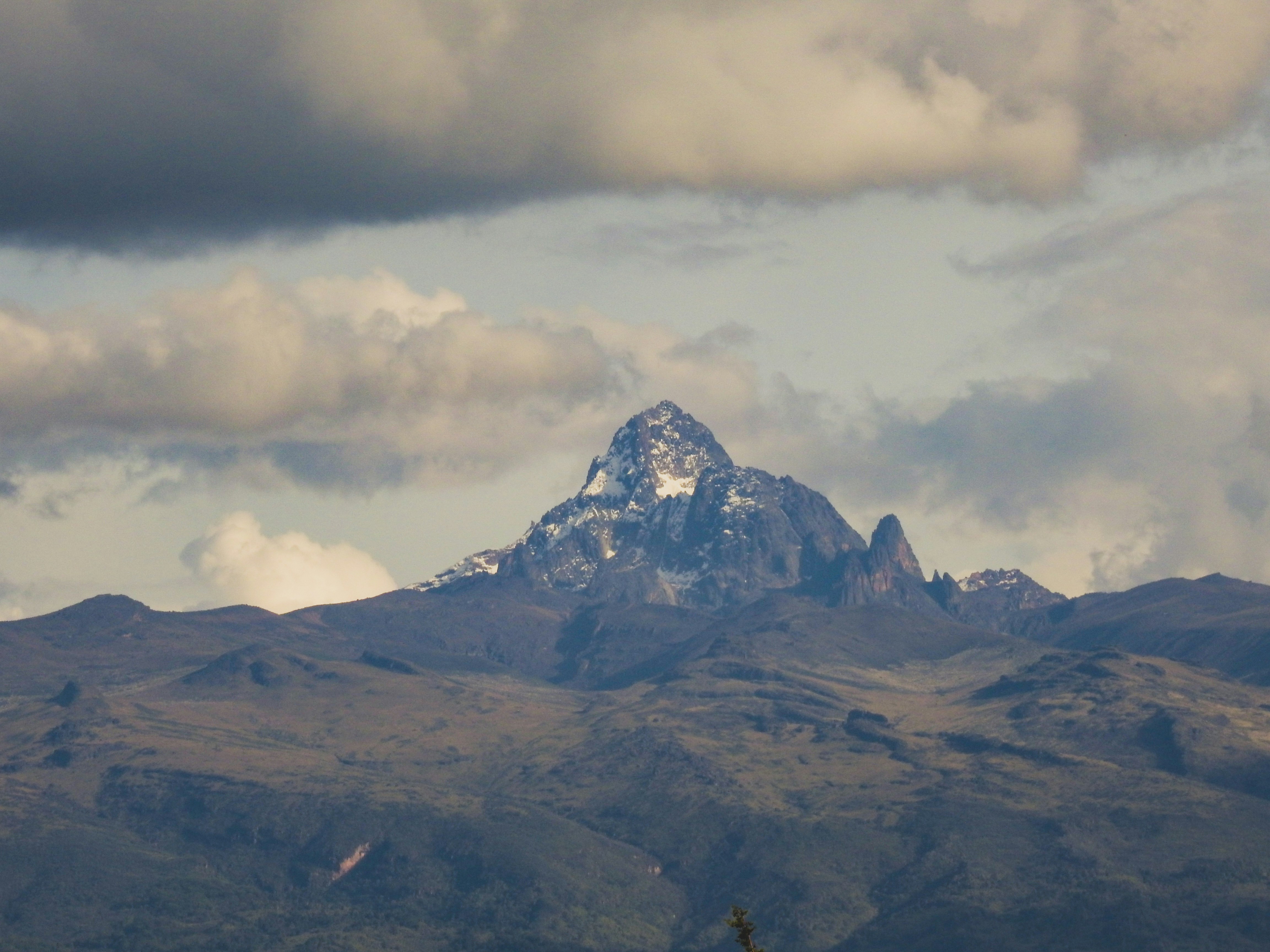 Mount Kenya summit with snow-capped peaks and dramatic clouds