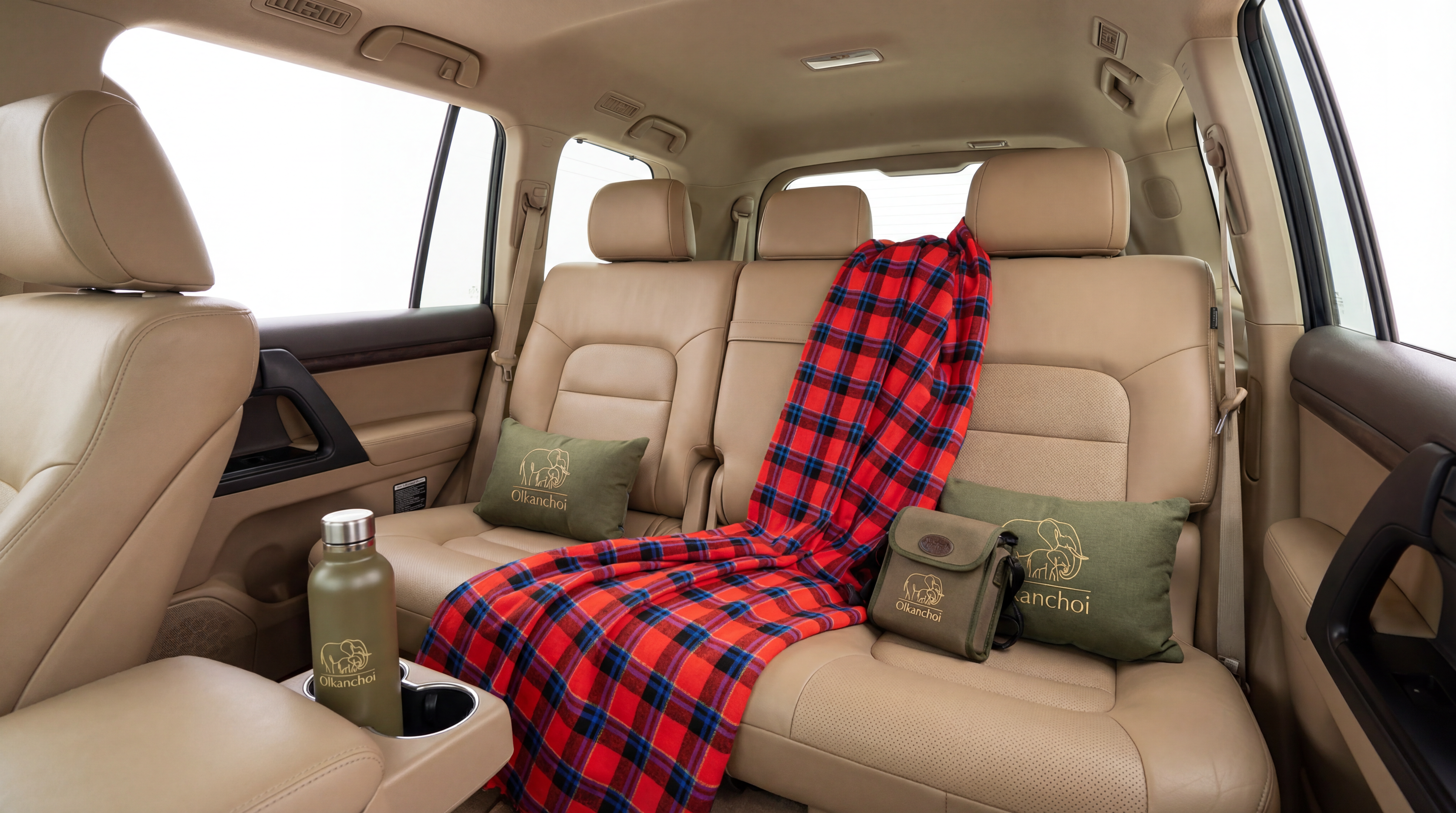 Olkanchoi Maasai-plaid blanket, branded pillows and thermos laid out in a Land Cruiser